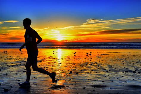 Man Running On The Beach At Sunset In Encinitas Sunset Running On