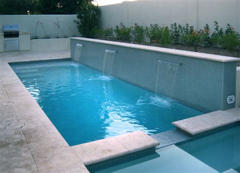 Here are ten gorgeous swimming pool water features you'll want to add to your backyard oasis. A swimming pool doubles as water feature in this compact ...
