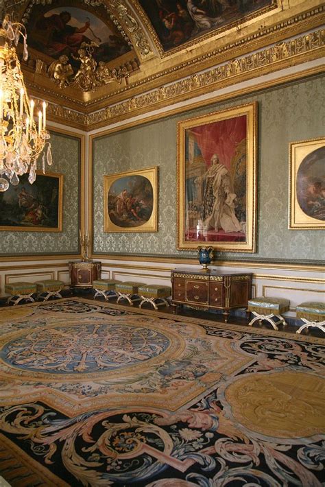 An Ornately Decorated Room With Chandeliers And Paintings On The Walls