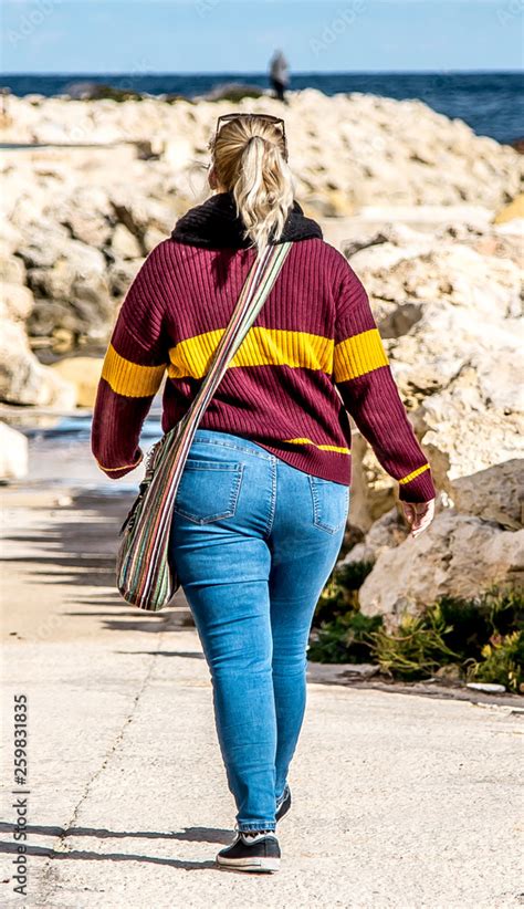 Woman With Big Booty In Jeans Walking Down The Street Photos Adobe Stock