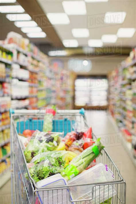 Full Shopping Cart In Grocery Store Aisle Stock Photo Dissolve