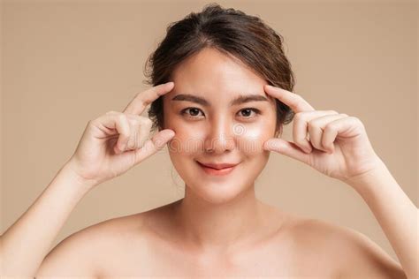 Closeup Beautiful Asian Woman Healthy Glowing Hydrated Skin On Beige