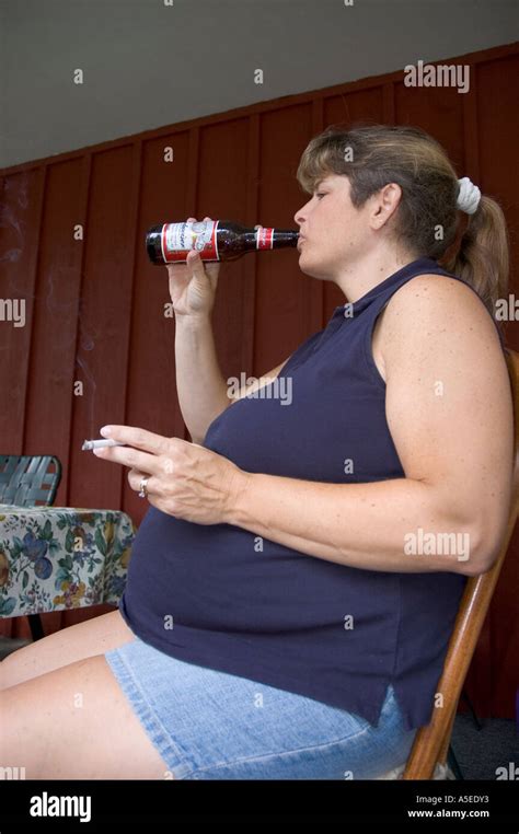 Pregnant Caucasian Woman Drinking Beer And Smoking Cigarette Stock