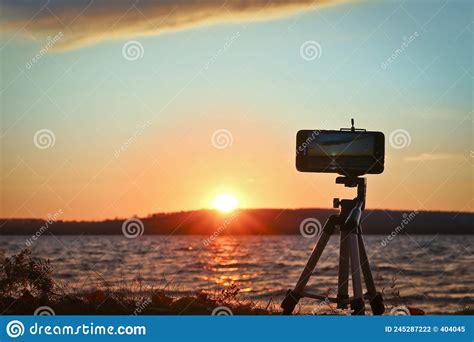 Shooting A Time Lapse With A Smartphone Of A Sunset Over A Lake