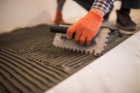 Check spelling or type a new query. Free Photo | Laying ceramic tiles. troweling mortar onto a ...
