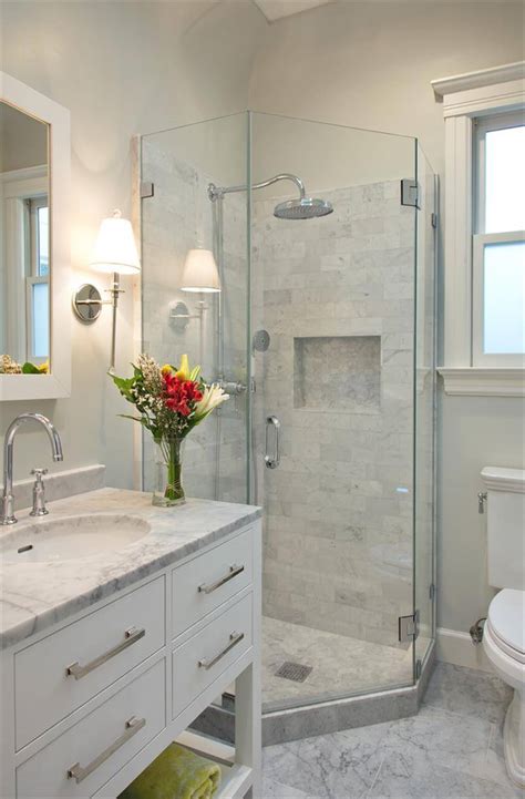 Choosing a mounted sink instead of a full vanity allowed space for a garbage can and small storage stool that can tuck behind the sink, as well as towel hooks just outside the shower door. 32 Best Small Bathroom Design Ideas and Decorations for 2021