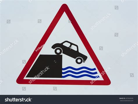 Road Sign Warning Of Car Falling Into The Sea In The Uk Stock Photo
