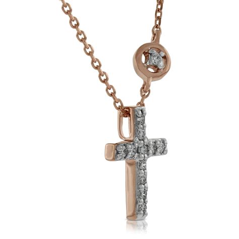 This stunning diamond pendant has been set with 7 diamonds totaling 0.18 carats in weight and is made from 18k rose gold. Rose Gold Diamond Cross Pendant 14K | Ben Bridge Jeweler