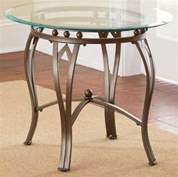 You can find end tables matching to your requirements. Madrid Round Glass Top End Table from Steve Silver ...