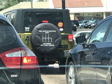A Tire Cover On The Back Of A Jeep Reads This Vehicle Equipped With