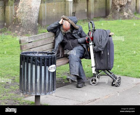 London Uk Mar 21 2021 Homeless Man Sleeping On A Bench In The Park