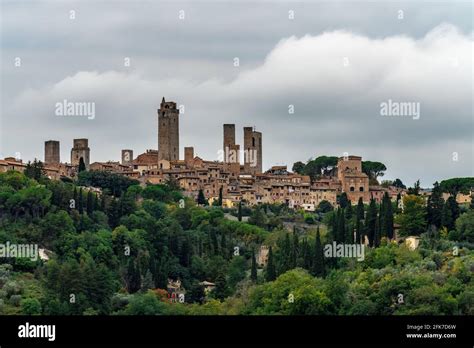 san gimignano town skyline and medieval towers sunset italian olive trees in foreground