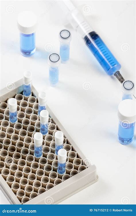 Loaded Syringe And Vials Containing Blue Fluid Stock Photo Image Of