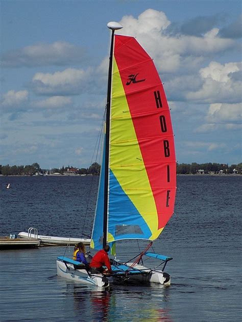 Two People In A Small Sailboat On The Water