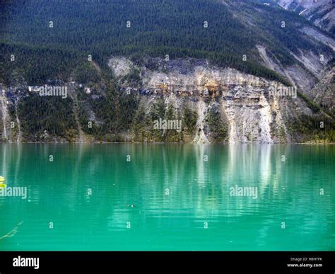 Rocky Mountainside Reflecting In Muncho Lake British Columbia Canada