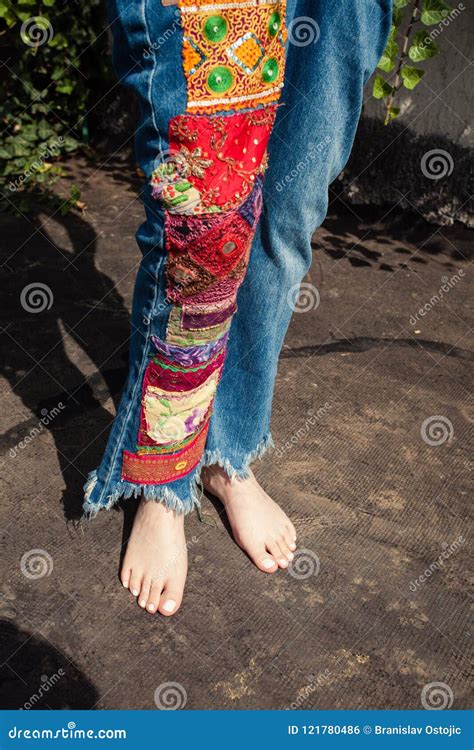 Barefoot Young Woman In Boho Style Embroidered Blue Jeans Lower Stock