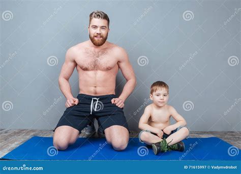 happy dad and son sitting on blue yoga mat together stock image image of health exercise
