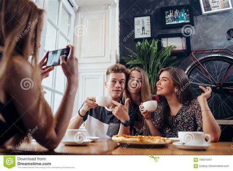 Group Of Cheerful Young People Posing In A Cafe Drinking Coffee Making