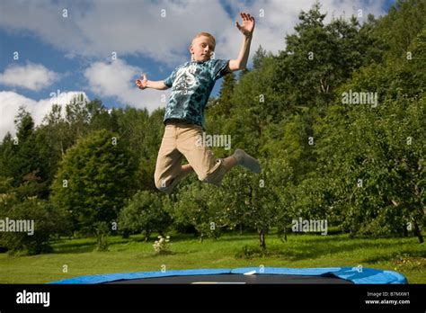 Teenage Boy Jumping On Trampoline Stock Photo Alamy