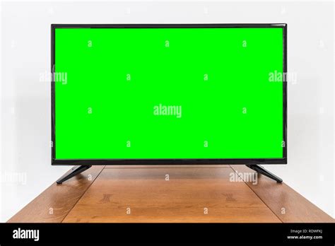 Modern Television On Old Table With Chroma Key Green Screen Stock Photo