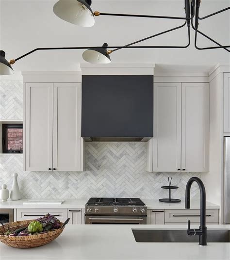 It's full of goodies, including this fab kitchen featured on the cover, designed by karen sealy of sealy design inc: Black dome kitchen range hood between light gray shaker ...