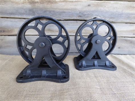 Two Black Reels Are Sitting Side By Side On A Burlap Cloth Covered Surface
