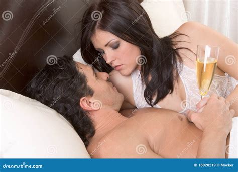Het Houden Van Van Jong Sensueel Paar Met Champagne In Bed Stock