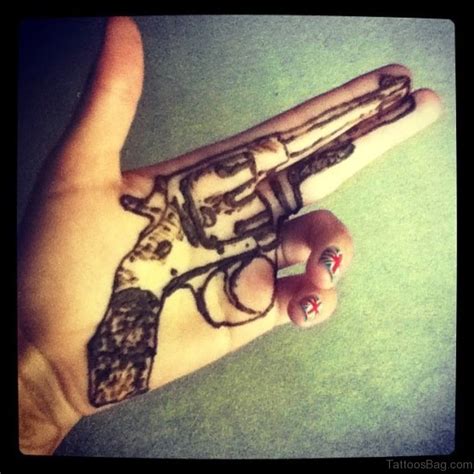 28 Funky Gun Tattoos On Hand Tattoo Designs