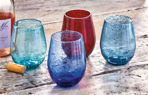 Three Different Colored Wine Glasses Sitting On Top Of A Table Next To