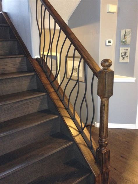 So, we decided to stain the banister and newel posts (and the wood that runs along the base of the spindles) and to paint each of the spindles a creamy oh wait — some of you have seen little snippets of the finished banister and even saw me writing about it a little bit on instagram over a year ago. BENT iron design interior railing with a distressed wood ...