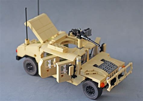 A Toy Army Vehicle Is Shown On A Gray Surface With An Antenna Attached
