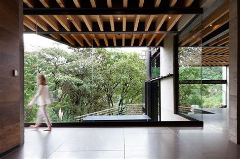 Outdoor Elevated Glass Walkway Connects Two Sections Of House