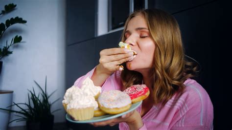 Eating woman enjoy cream cupcake. Food calories. Close up hungry ...