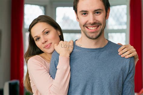 Portrait Of A Young Couple Woman With Hands On Man Shoulder Picture And