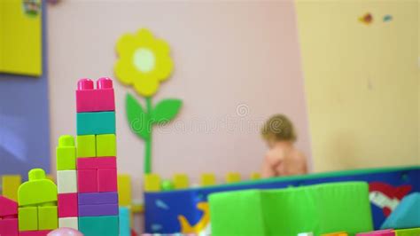 Happy Kids Playing With Soft Multi Coloured Blocks At Indoor Playground