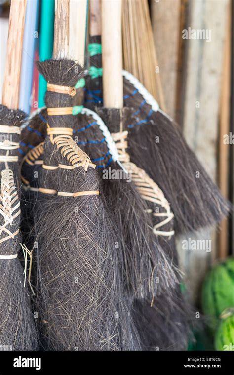 Selective Focus On Group Of Old Fashioned Straw Brooms For Sell In