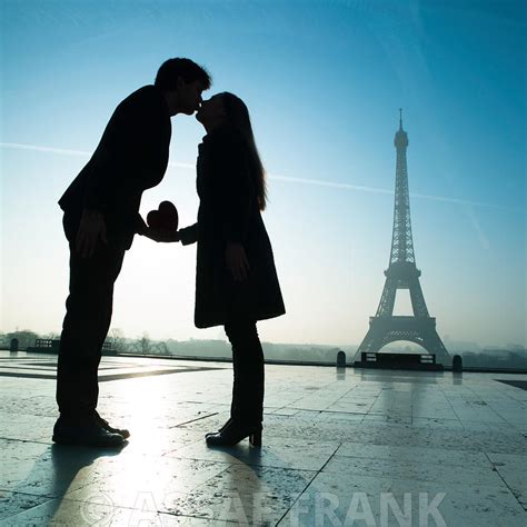 assaf frank photography licensing a couple kissing next to the eiffel tower