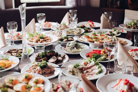 Banquet Table Served With Various Cold Snacks And Salads Stock Image