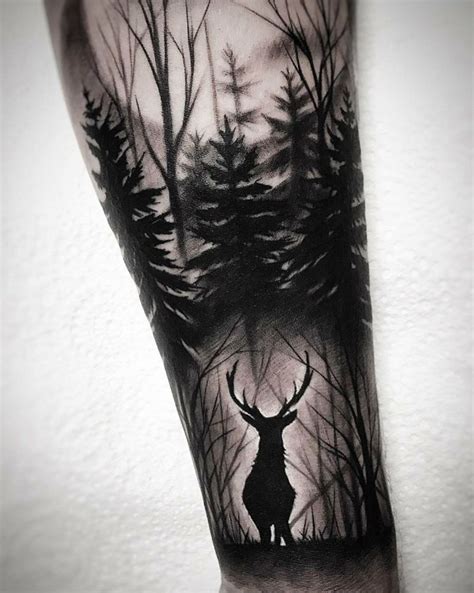 A Mans Arm With A Black And White Tattoo Of A Deer In The Woods