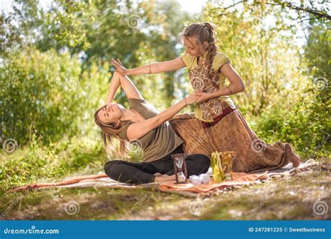 Girl Masseuse Demonstrates Refreshing Massaging Methods In A Forest