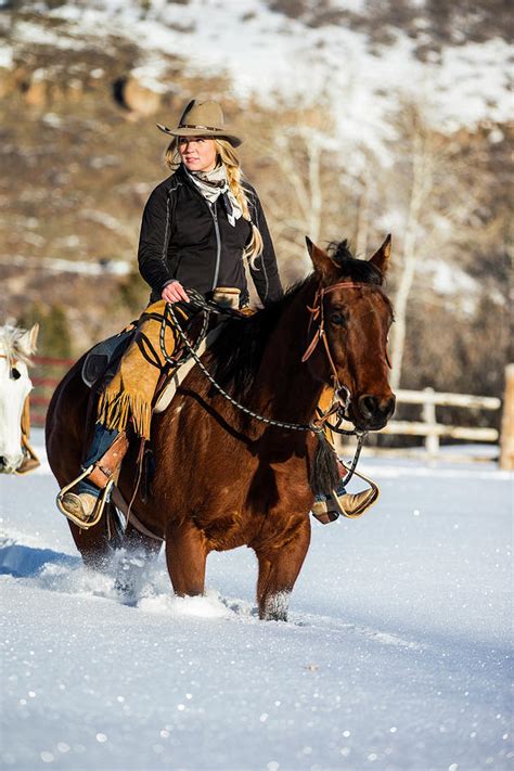 A Cowgirl Riding Her Horse In The Snow Photograph By Mike Schirf
