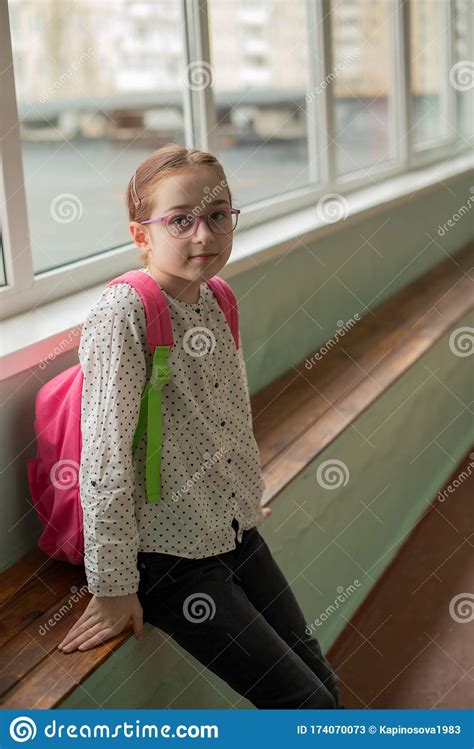 Girl 9 Years Old With A School Backpack On Her Back Portrait Of A