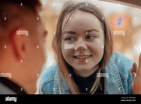 Funny Girl With A Turned Up Nose Saying Good Bye To Boy Through A Car