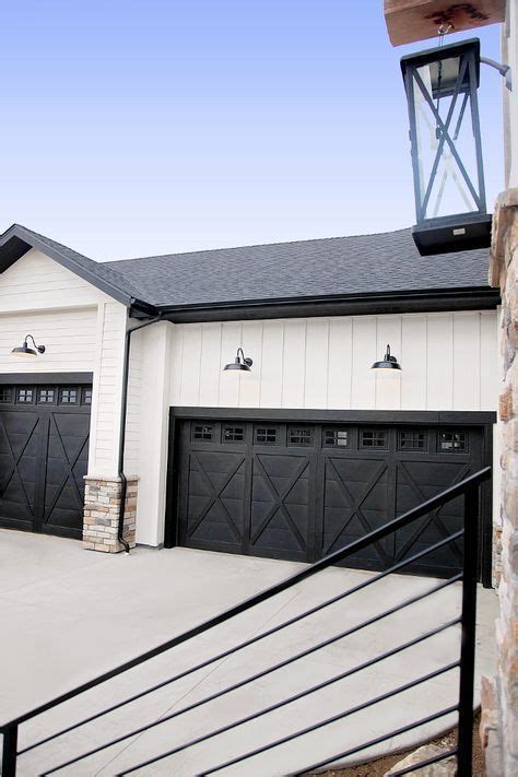 Planks doors in accents woodtones with custom elegant black the farmhouse exterior design totally reflects the entire style of the house and the family tradition as well. Farmhouse garage. Great rustic look + black and white ...