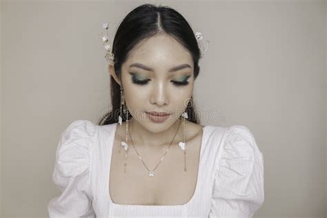 Close Up Beauty Face Of Asian Young Model Wearing Ear Accessories Or
