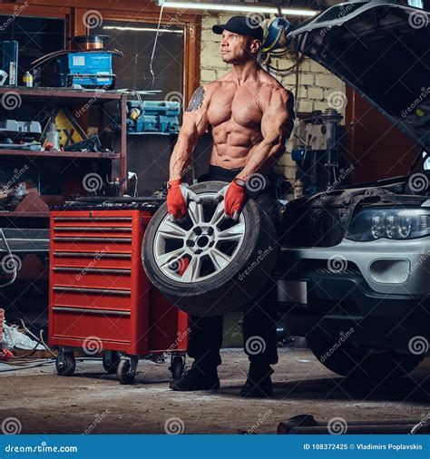 A Man Repairing Wheel Of A Car Stock Image Image Of Bodybuilder Engine