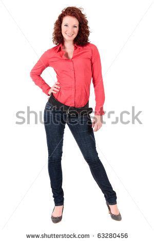 Woman In Red Shirt And Jeans Posing For The Camera With Her Hands On