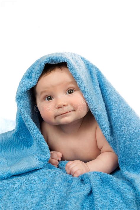 Newborn Baby Lying Down And Smiling In A Blue Towel Stock Photo Image