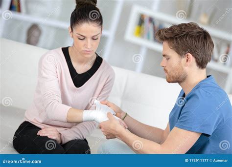 Boyfriend Helping To Bandage Girlfrien Wrist Stock Image Image Of