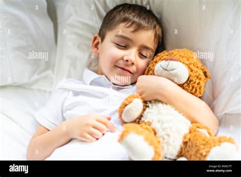 A Little Boy In Bed Sleeping And Dreaming Stock Photo Alamy